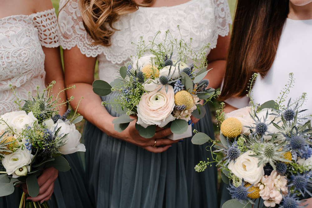 Outdoor Farm Field Marquee Bridesmaids White Green Blue Yellow Wildflower Bouquets Grey Skirts Separates | Rustic and Relaxed Spring Tipi Wedding Inbetween Days Photography
