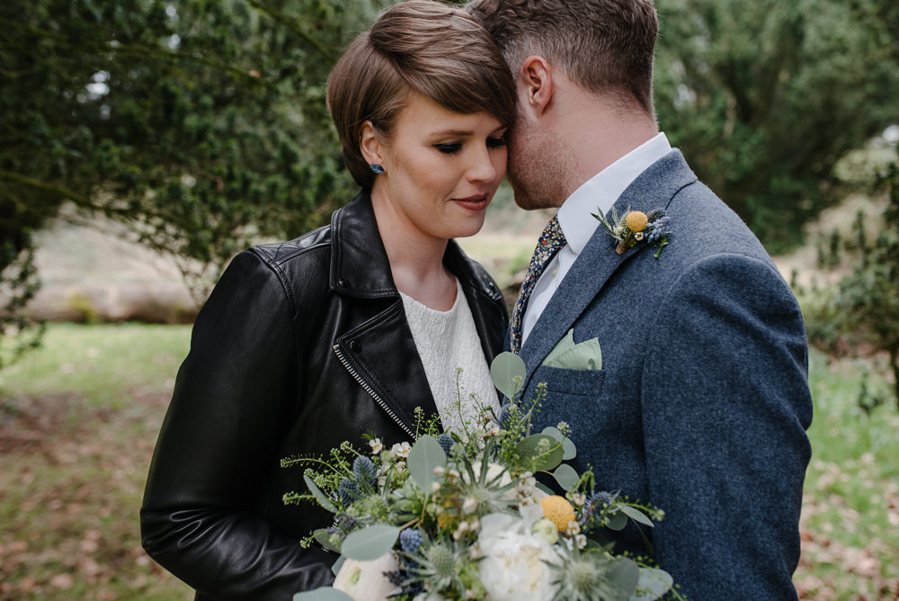 Outdoor Farm Field Marquee Groom Bride Leather Jacket Blue Suit Modern Green Yellow Bouquet | Rustic and Relaxed Spring Tipi Wedding Inbetween Days Photography