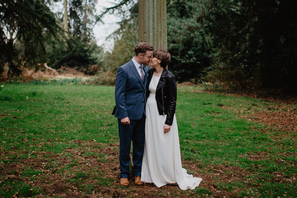 Outdoor Farm Field Marquee Groom Bride Leather Jacket Blue Suit Modern | Rustic and Relaxed Spring Tipi Wedding Inbetween Days Photography