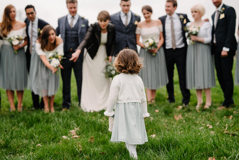 Outdoor Farm Field Marquee Bride Bridesmaids Groom Groomsmen Blue Navy Suits Yellow Buttonholes Flower Girl | Relaxed and Rustic Spring Tipi Wedding Inbetween Days Photography