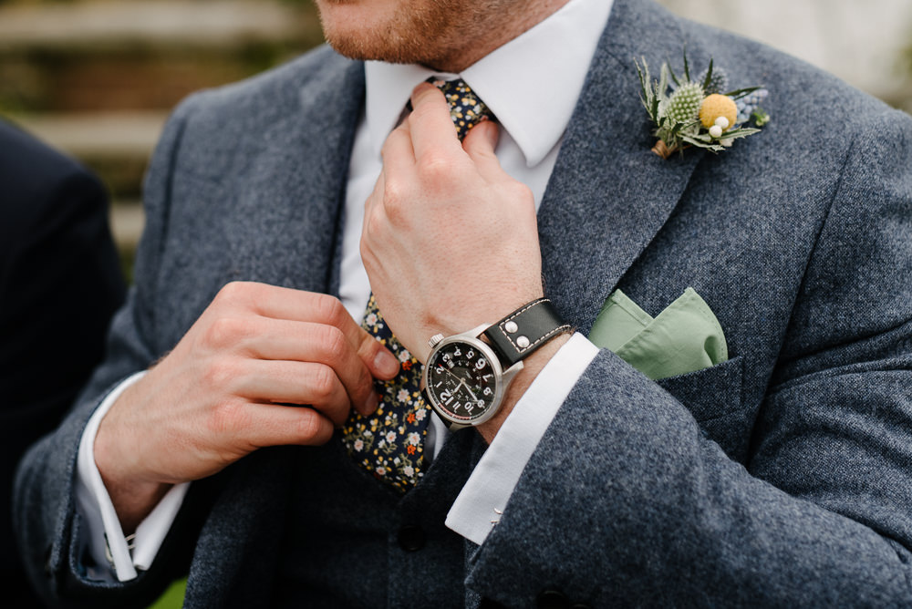 Outdoor Farm Field Marquee Blue Yellow White Floral Tie Buttonhole | Rustic and Relaxed Spring Tipi Wedding Inbetween Days Photography
