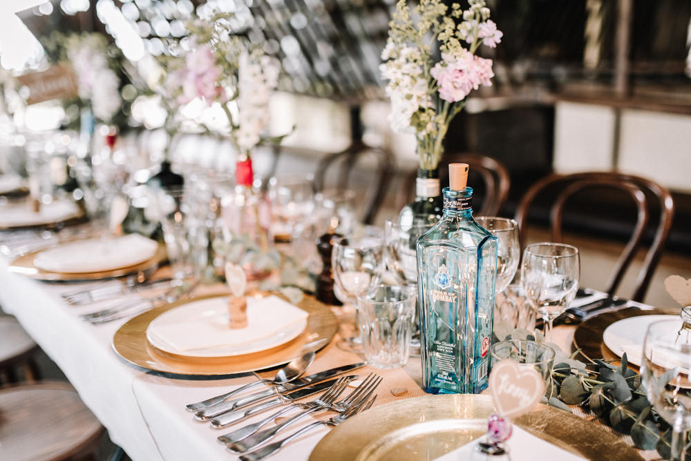 Gin Bottle Flowers Table Pretty Pink Greenery Decor Stone Barn Wedding Oobaloos Photography