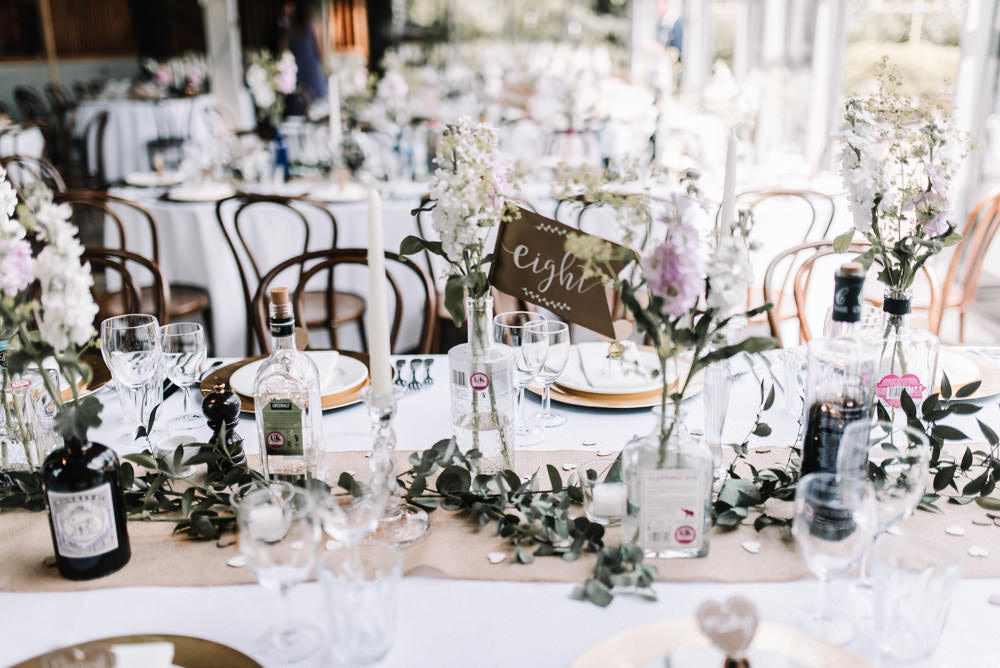 Gin Bottle Flowers Table Pretty Pink Greenery Decor Stone Barn Wedding Oobaloos Photography