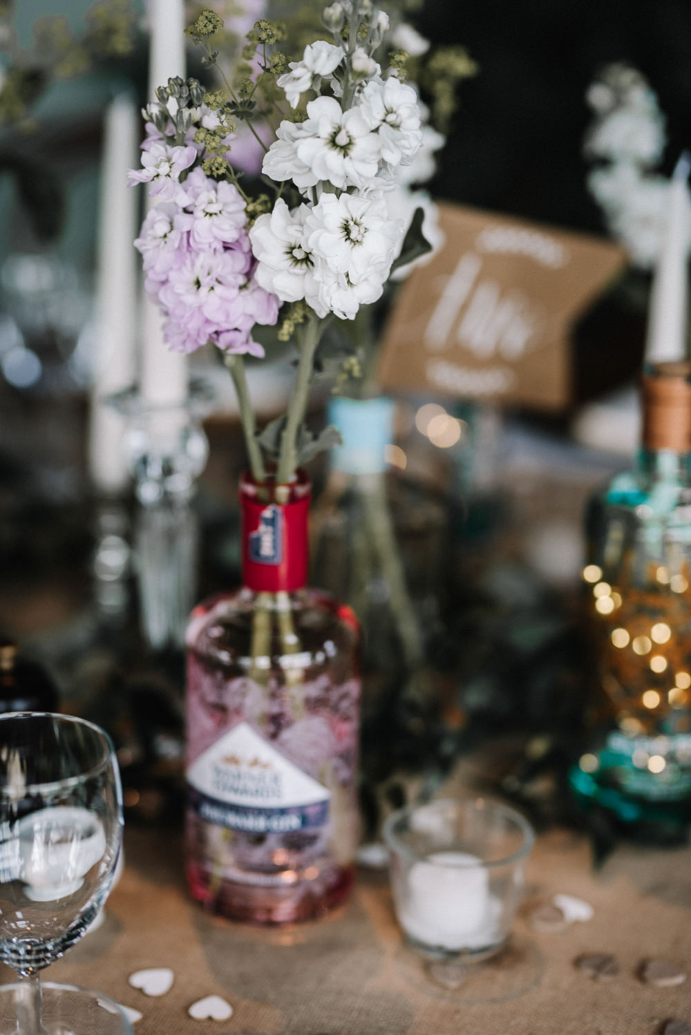 Gin Bottle Flowers Table Pretty Pink Greenery Decor Stone Barn Wedding Oobaloos Photography