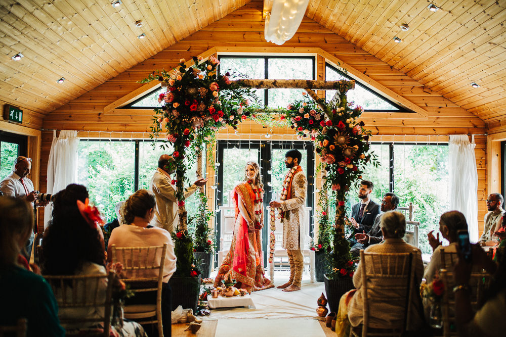 Styal Lodge Multicultural English Orange Pink Mandap Ceremony Traditional Ritual Aisle Bride Groom | Modern and Colorful Indian Wedding Emilie May Photography