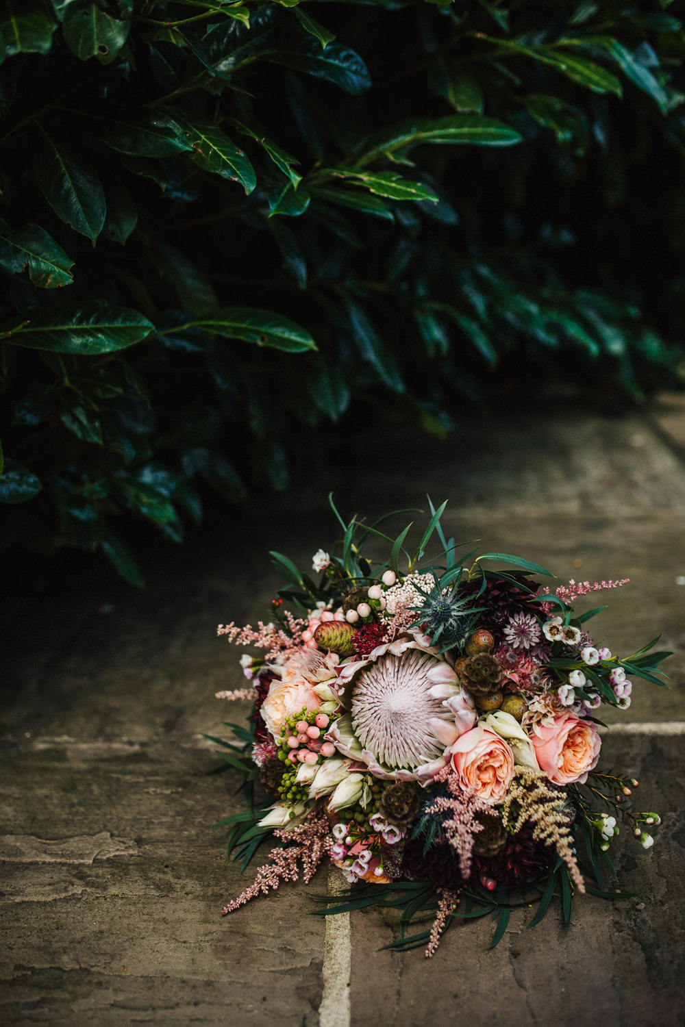 Styal Lodge Multicultural English Orange Pink Bride Bouquet Protea Wild Untamed | Modern and Colorful Indian Wedding Emilie May Photography
