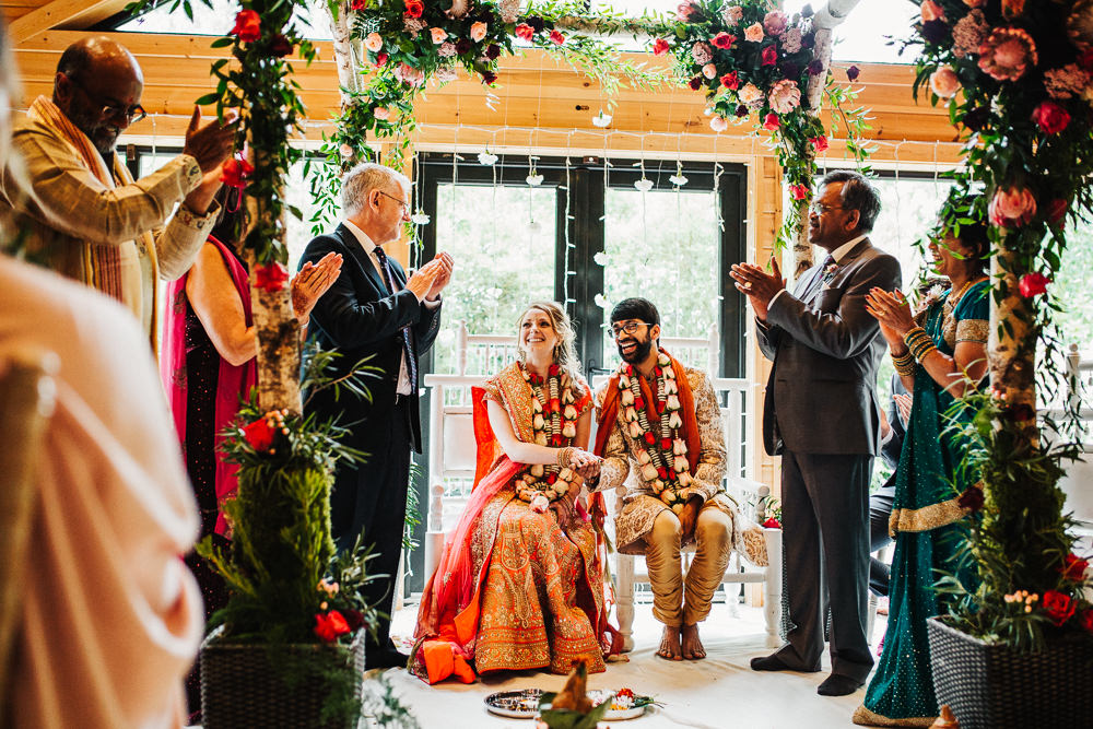 Styal Lodge Multicultural English Orange Pink Mandap Ceremony Traditional Ritual Aisle Bride Groom | Modern and Colorful Indian Wedding Emilie May Photography