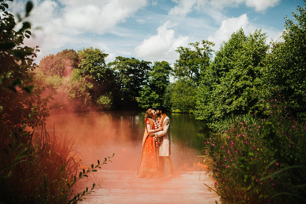 Styal Lodge Multicultural English Orange Smoke Bomb Bride Groom Forest Field | Modern and Colorful Indian Wedding Emilie May Photography