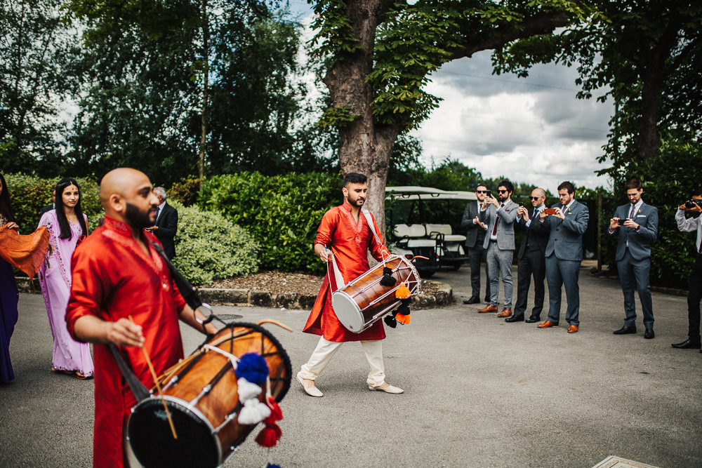 Styal Lodge Multicultural English Orange Pink Groom Entrance Dhol Drums | Modern and Colorful Indian Wedding Emilie May Photography