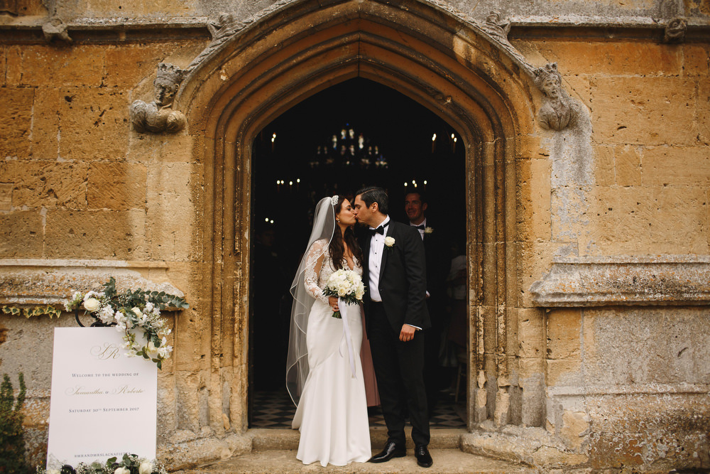 Cotswolds Royal Castle Summer Autumn Traditional Classic Elegant Groom Bride Ceremony Church Kiss | Sudeley Castle Wedding ARJ Photography