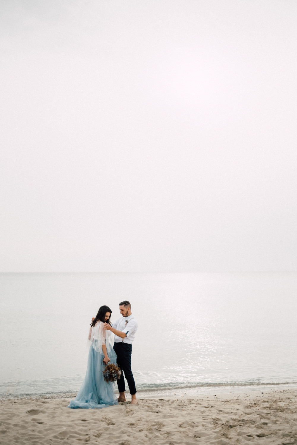 Outdoor Wild Nature Destination Spain Europe Beach Styled Shoot Groom Braces Bride Blue Gown Lace | Blue Ibiza Elopement Ideas and Surprise Proposal Serena Genovese Photography