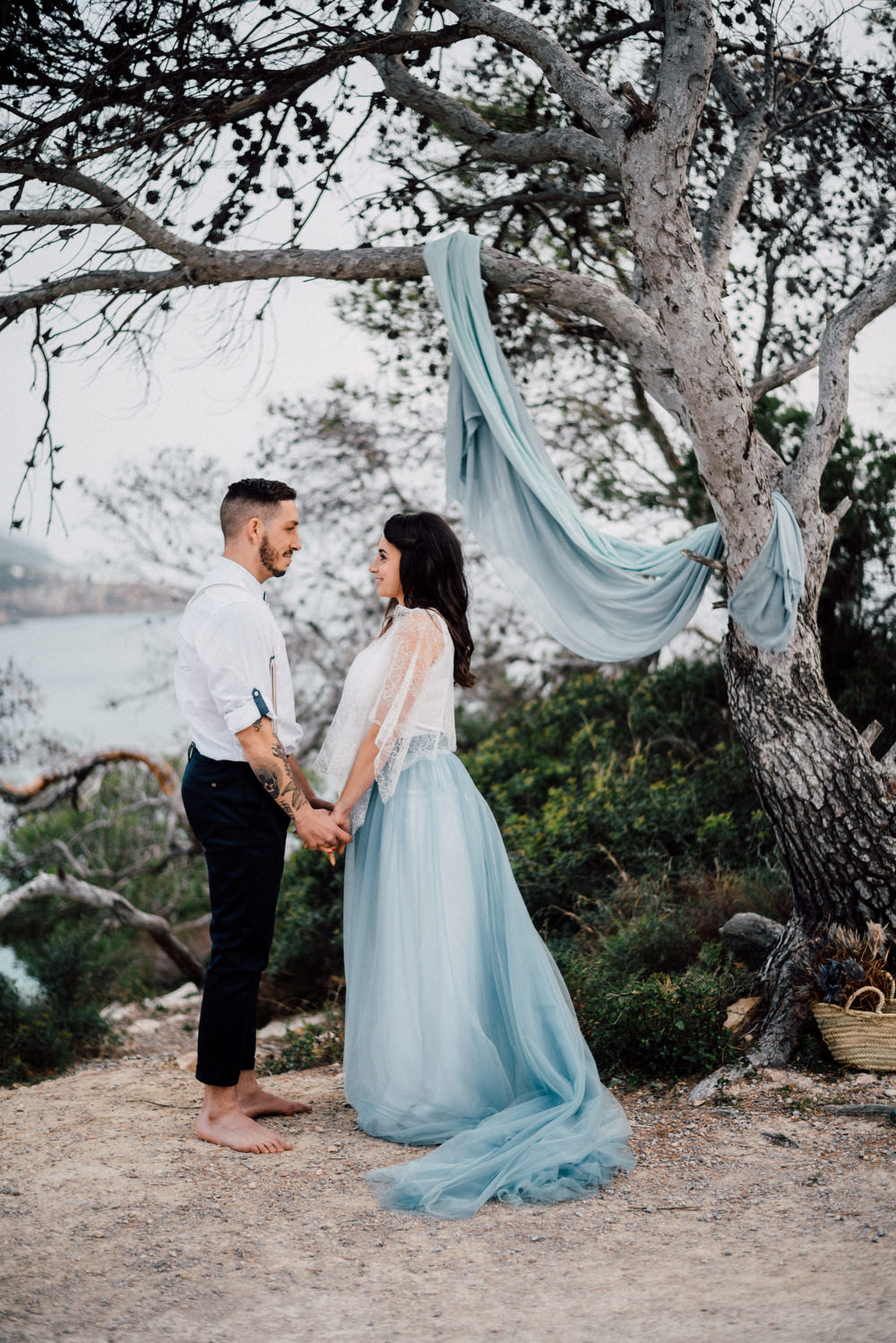 Outdoor Wild Nature Destination Spain Europe Sea Beach Styled Shoot Groom Braces Bride Blue Gown Lace Ceremony | Blue Ibiza Elopement Ideas and Surprise Proposal Serena Genovese Photography