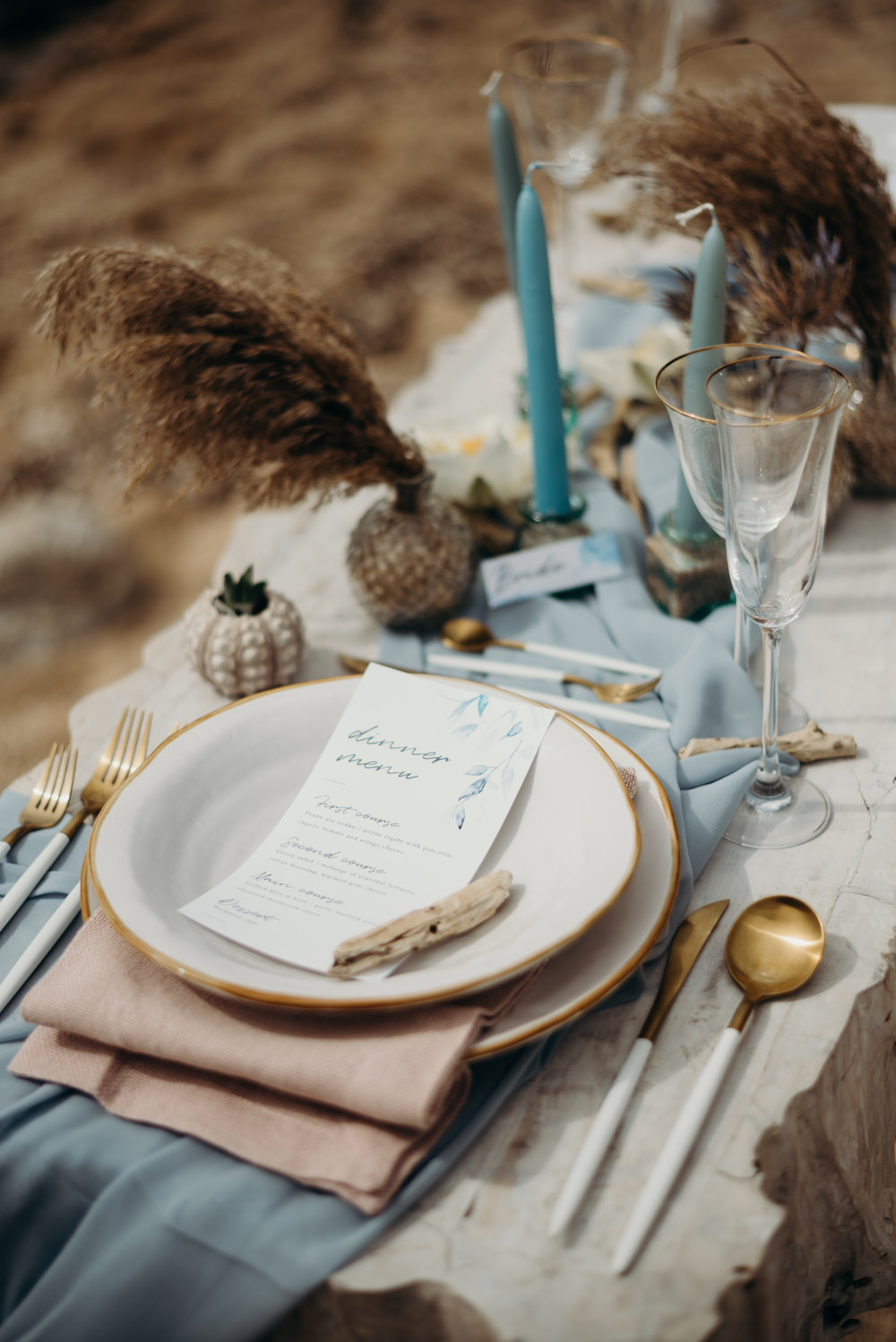 Outdoor Wild Nature Destination Spain Europe Coastal Styled Shoot Beach Table Elegant Styling Menu Candles Cutlery | Blue Ibiza Elopement Ideas and Surprise Proposal Serena Genovese Photography