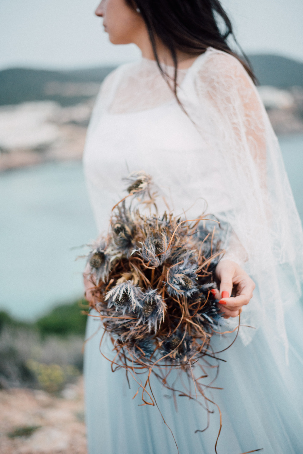 Outdoor Wild Nature Destination Spain Europe Sea Beach Styled Shoot Bride Blue Gown Lace Sea Holly Bouquet | Blue Ibiza Elopement Ideas and Surprise Proposal Serena Genovese Photography