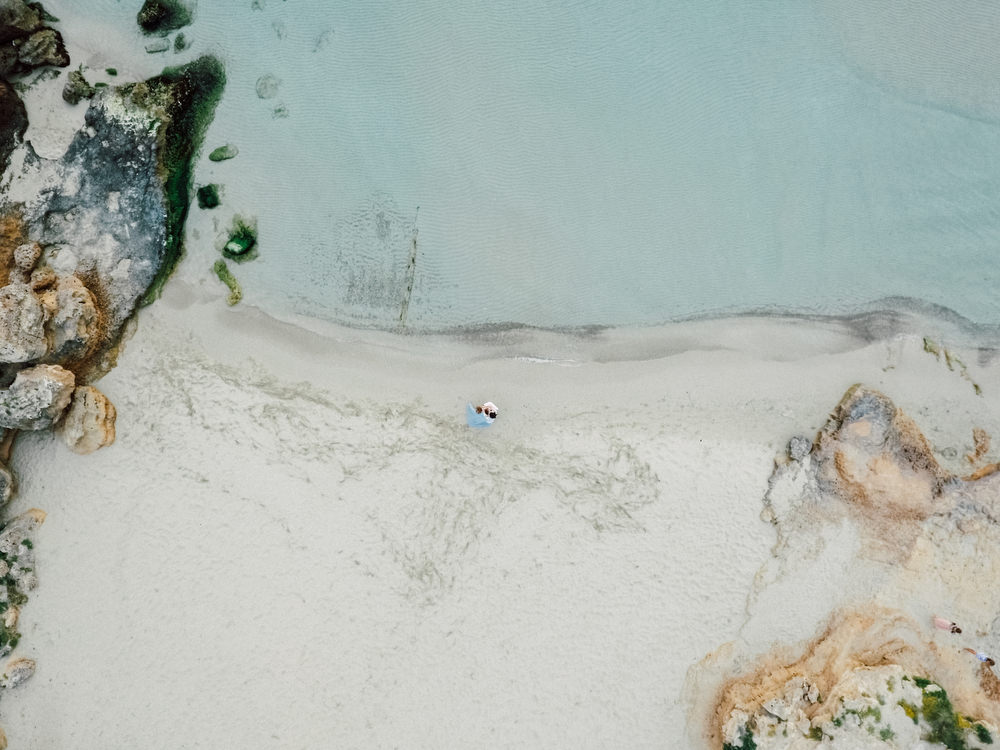Outdoor Wild Nature Destination Spain Europe Sea Beach Styled Shoot Groom Braces Bride Blue Gown Lace | Blue Ibiza Elopement Ideas and Surprise Proposal Serena Genovese Photography
