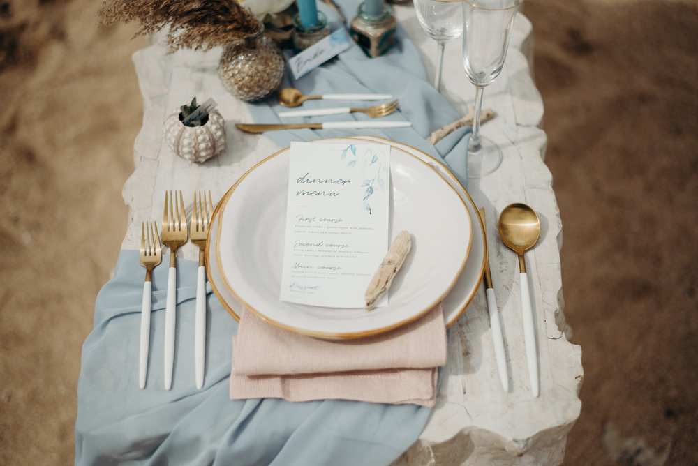Outdoor Wild Nature Destination Spain Europe Coastal Styled Shoot Beach Table Elegant Styling Menu Driftwood | Blue Ibiza Elopement Ideas and Surprise Proposal Serena Genovese Photography