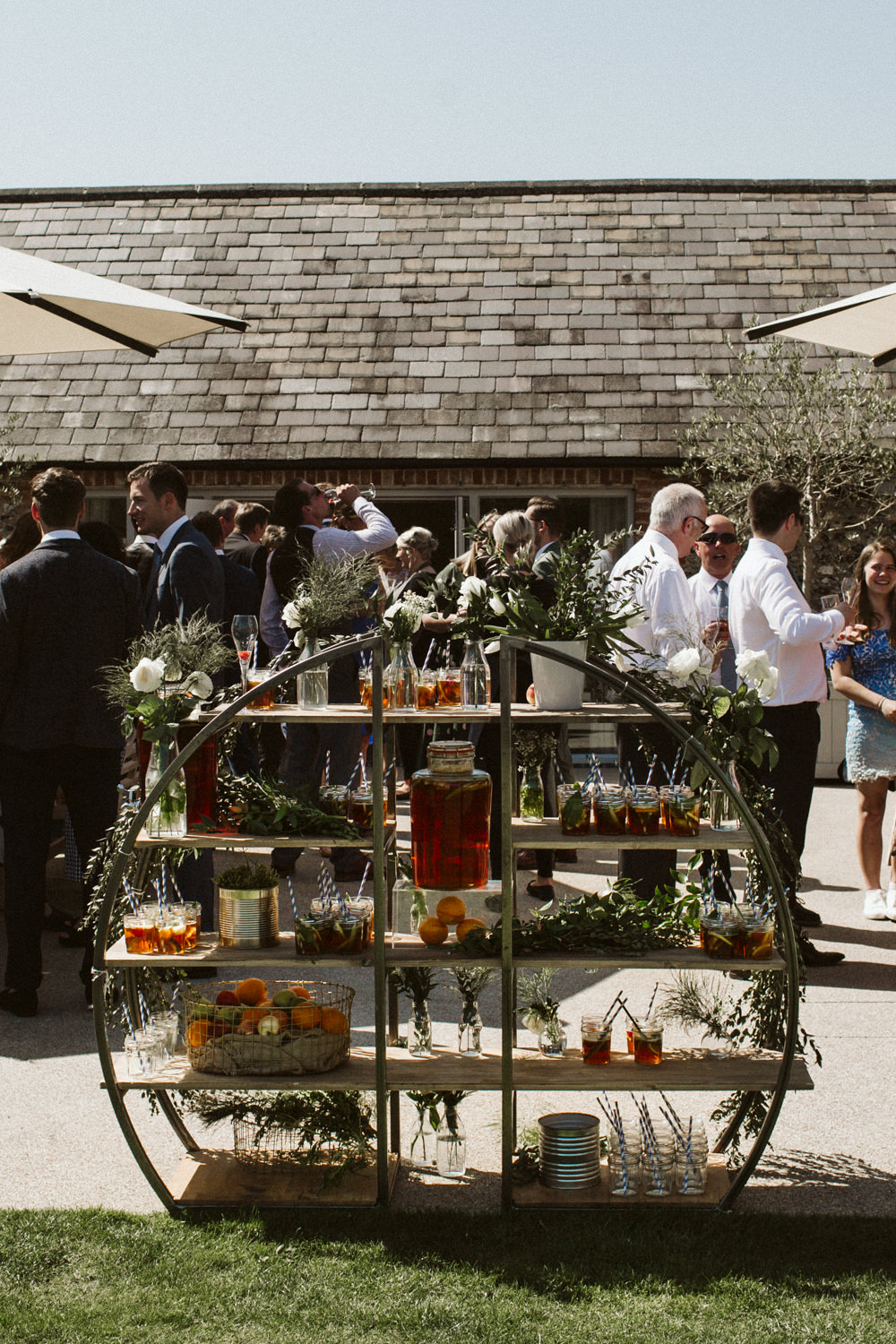 Travel Wine Inspired Rustic Outdoor Natural Farm Field Drinks Reception Circular Shelves Greenery | Farbridge Barn Wedding Jamie Dunn Photography