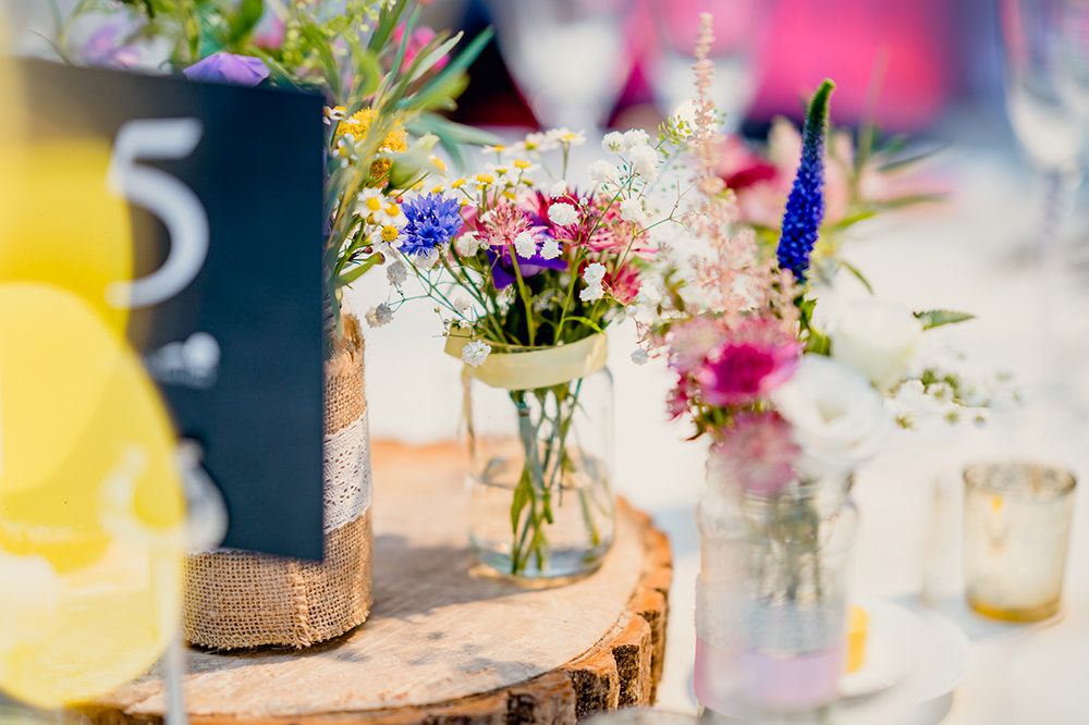 Wood Slice Multicoloured Wedding Table Centre Jam Jars Heaton House Farm Wedding Steven Rooney Photography