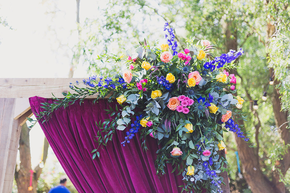 Flower Arch Florals Wooden Frame Multi Colour Colourful Backdrop Hothorpe Hall Woodlands Wedding Lucy Long Photography