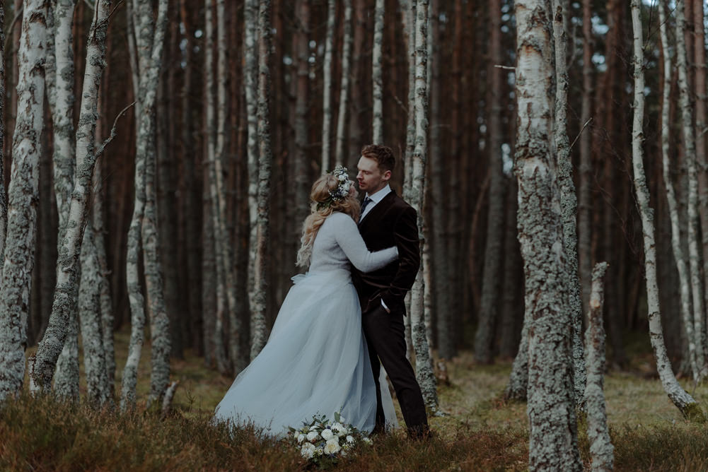 Forest Trees Castle Loch Bride Groom Blue Dress White Bouquet Floral Crown Cape Tan Coat | Intimate Winter Outdoor Scotland Wedding Christopher Ian Photography