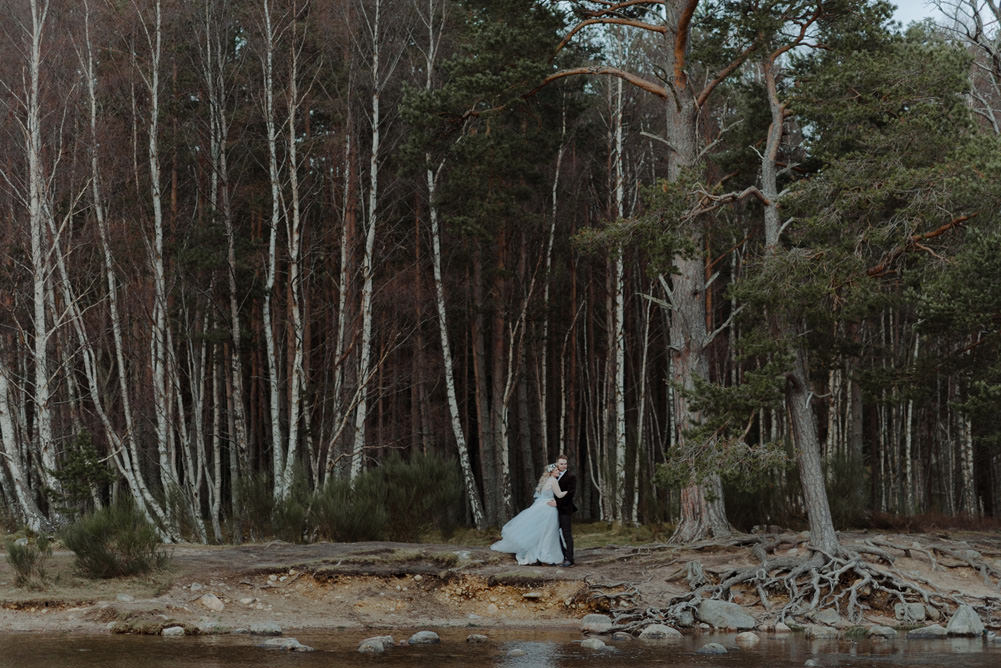 Forest Trees Castle Loch Bride Groom Blue Dress White Bouquet Floral Crown Cape Tan Coat | Intimate Winter Outdoor Scotland Wedding Christopher Ian Photography