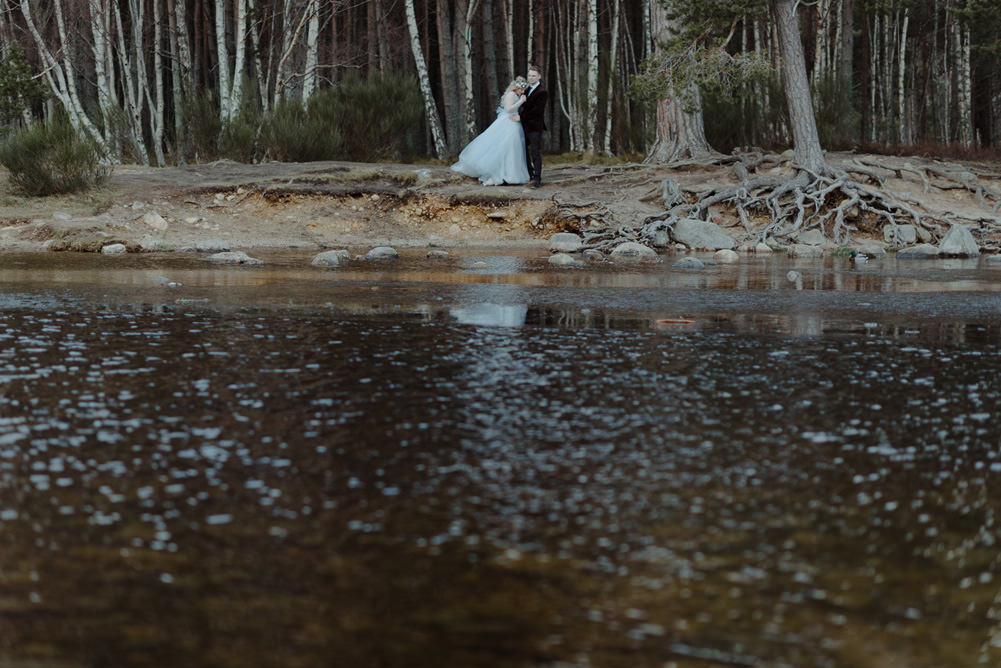 Forest Trees Castle Loch Bride Groom Blue Dress White Bouquet Floral Crown Cape Tan Coat | Intimate Winter Outdoor Scotland Wedding Christopher Ian Photography