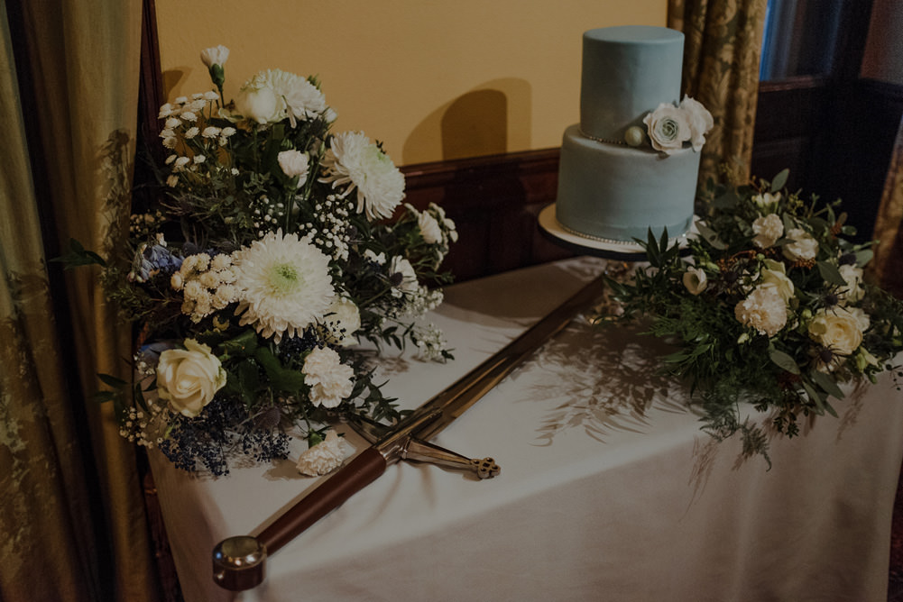 Forest Trees Castle Loch Simple Decor Greenery Fairy Lights Garland Runner Table Blue White Cake Sword | Intimate Winter Outdoor Scotland Wedding Christopher Ian Photography