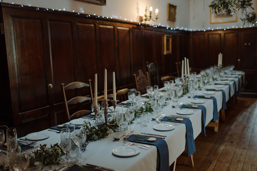 Forest Trees Castle Loch Simple Decor Greenery Fairy Lights Garland Runner Table Blue White | Intimate Winter Outdoor Scotland Wedding Christopher Ian Photography