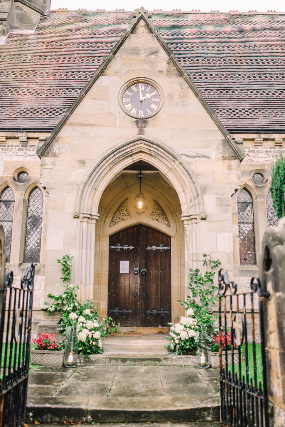 Church Entrance Flowers Hydrangea Rose Greenery Foliage Eucalyptus Arch Door Candles Pheasant Harome Wedding Yorkshire Arabella Smith Photography