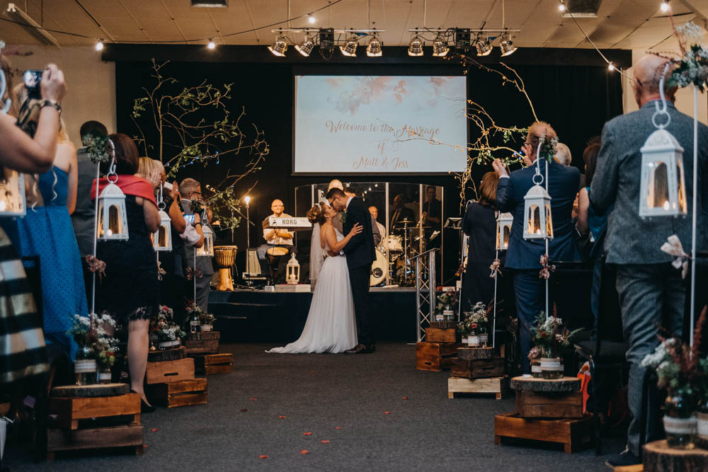 Bride Bridal Lace Dress Gown Train Tiara Veil Sequin Embellished Bouquet Navy Moss Bros Groom Wooden Crates Tower Shepherds Crook Tealight Lantern Flowers Florals Jar Railway Barn Wedding Lottie Photography