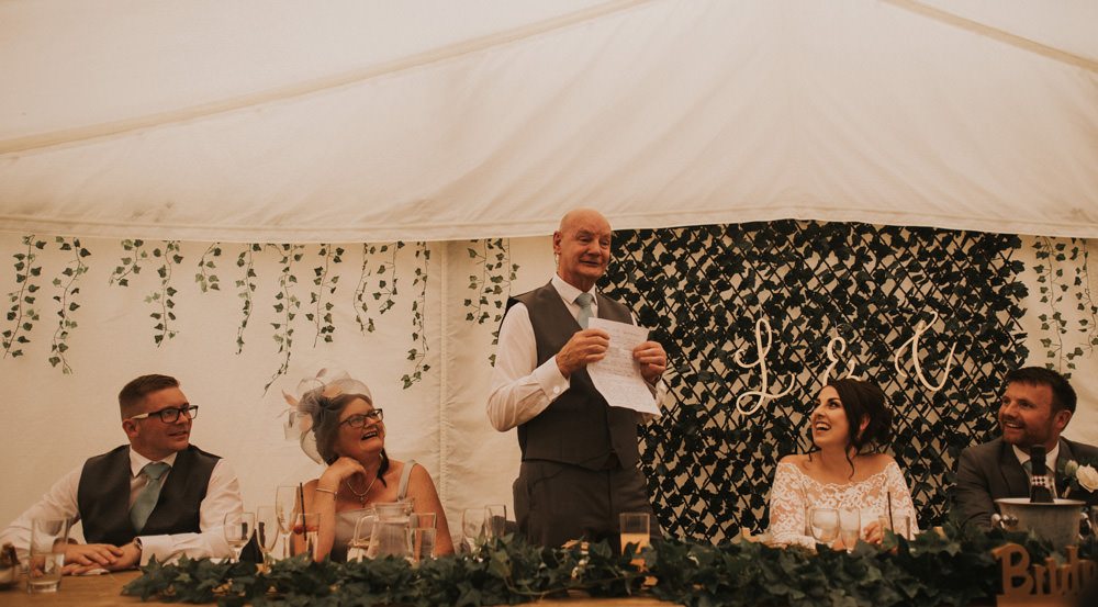 Outdoor Farm Field Wheat Rustic Garden Marquee Foliage Garland Backdrop Wooden Trestle Speeches | Fun and Relaxed Scrivelsby Walled Garden Wedding Brook Rose Photography