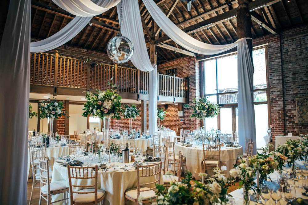 Tall Centrepiece Table Decor Flowers Greenery Foliage Drapes Disco Ball Barn Warm Welcoming Wedding Three Flowers Photography