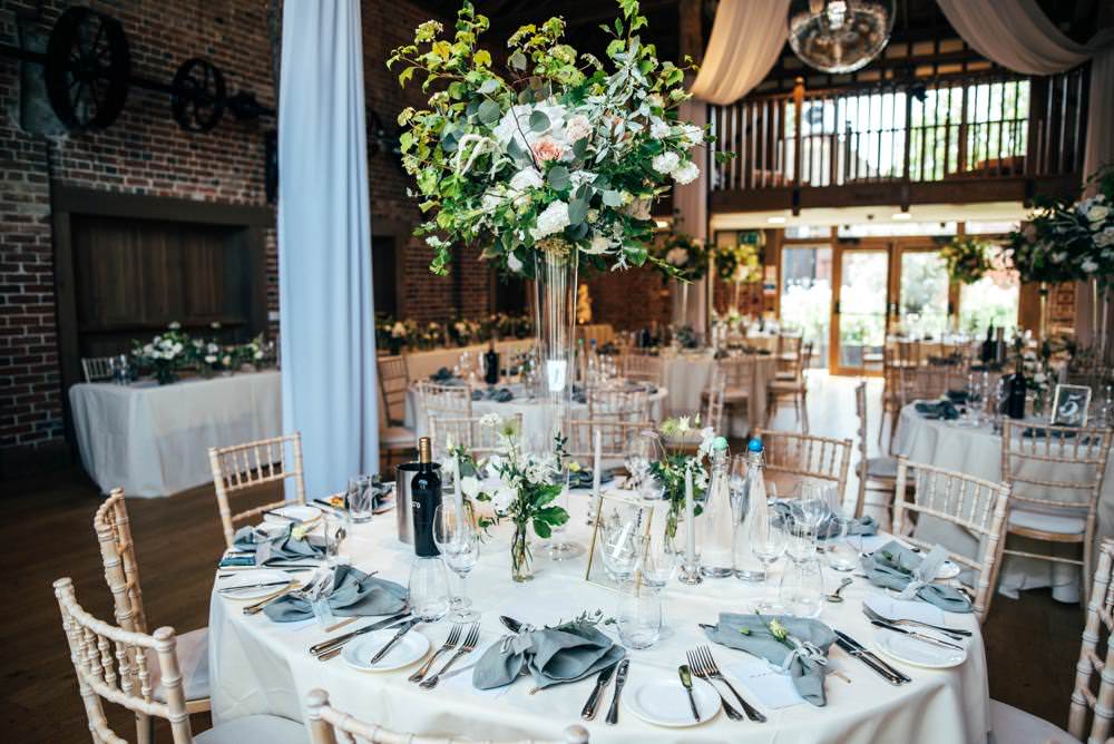 Tall Centrepiece Table Decor Flowers Greenery Foliage Warm Welcoming Wedding Three Flowers Photography