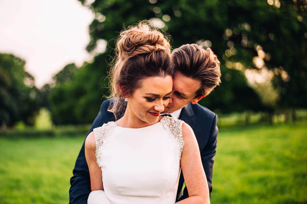 Hair Bride Bridal Messy Bun Up Do Style Warm Welcoming Wedding Three Flowers Photography
