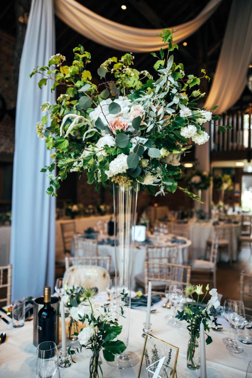 Tall Centrepiece Table Decor Flowers Greenery Foliage Warm Welcoming Wedding Three Flowers Photography