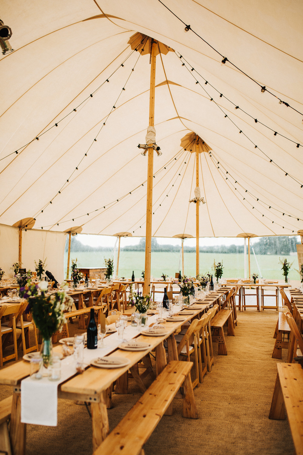 Wooden Tables Benches Chairs Festoon Lighting Whimsical Countryside Sperry Tent Wedding Emilie May Photography