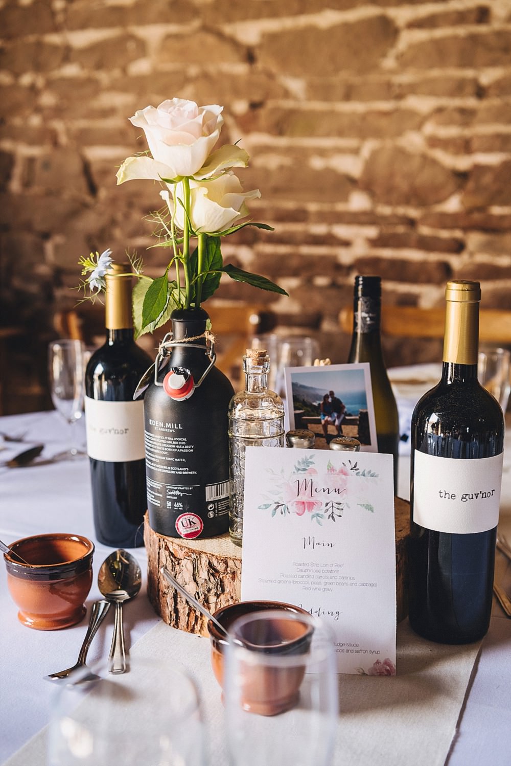 Centrepiece Table Flowers Bottles Log DIY Home Barn Tipi Wedding Marta May Photography