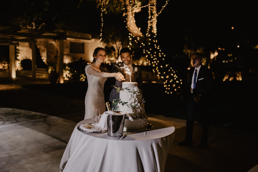 Bride Bridal Fishtail Lace Cap Sleeve Sweetheart Dress Gown Groom Dark Grey Waistcoat Cake Cutting Sparkler Greece Destination Wedding Elena Popa Photography