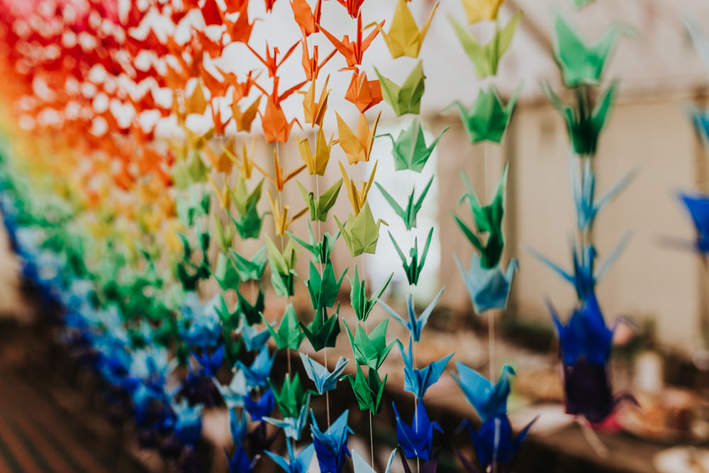 Keeper and The Dell Boho Farm Field Marquee DIY Alternative Rustic Reception Hanging Rainbow Origami Cranes | Relaxed Outdoor Wedding with 1000 Rainbow Origami Cranes Dan Biggins Photography