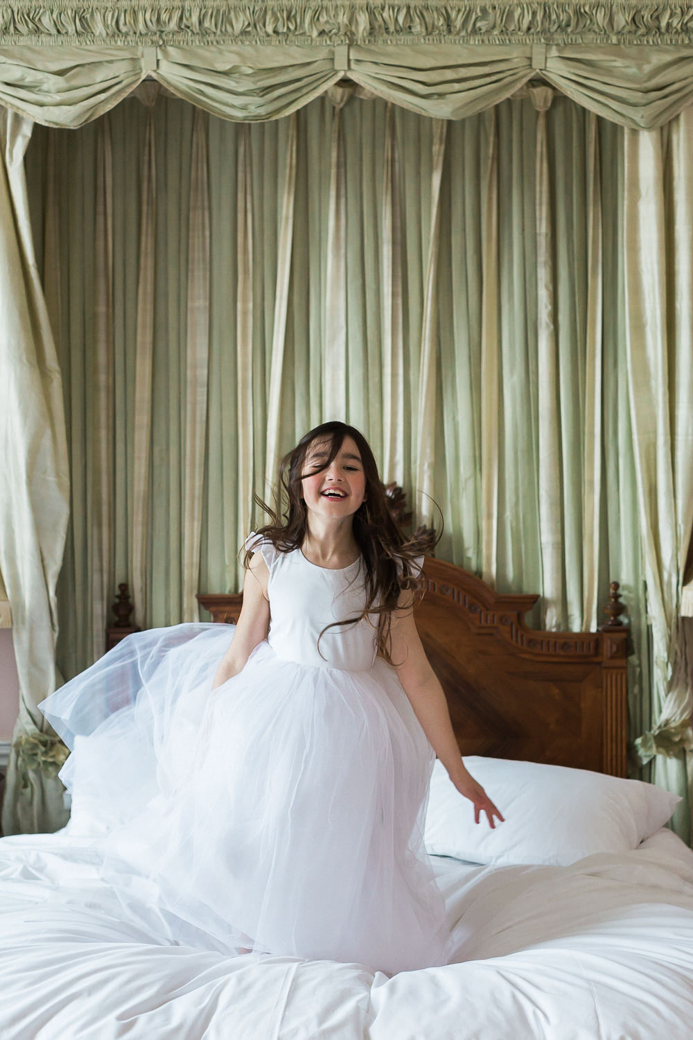 Modern Dance Ballet Inspired Fine Art Editorial Somerley House Morning Flower Girl Gilly Gray Jumping on Bed | Romantic Soft Wedding Ideas Siobhan H Photography