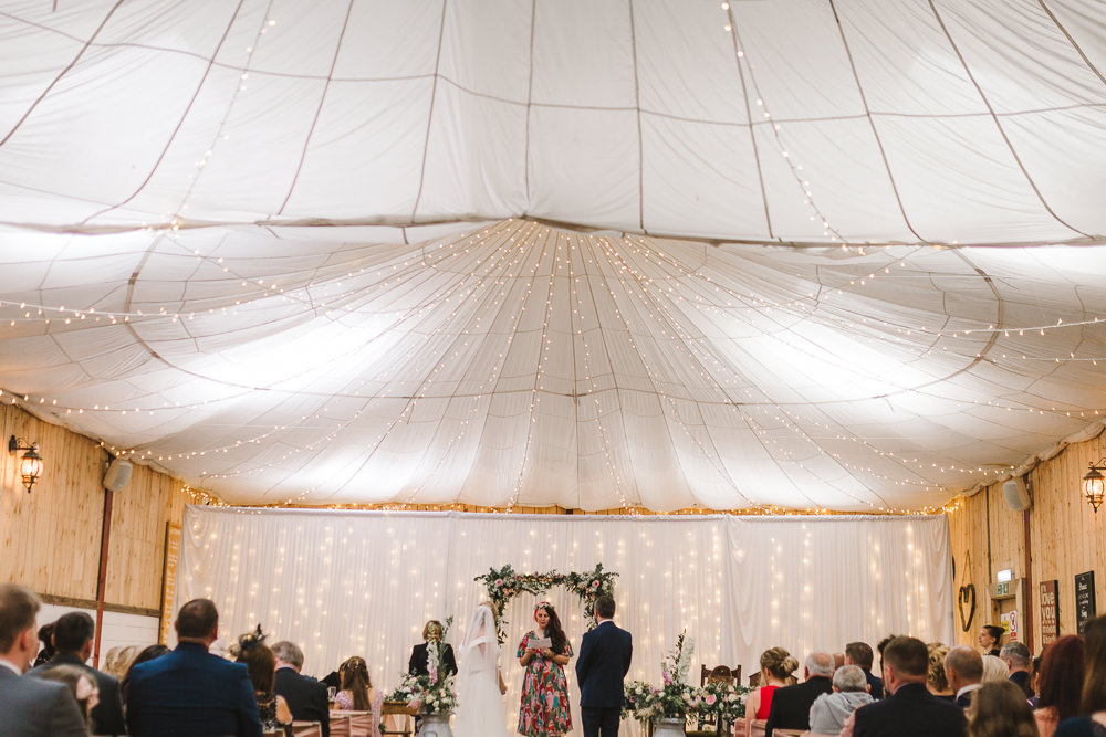 Ceremony Room Drapes Fairy Lights Ceiling Flowers Aisle Arch Floral Pink Greenery Wellbeing Farm Wedding Anna Wood Photography