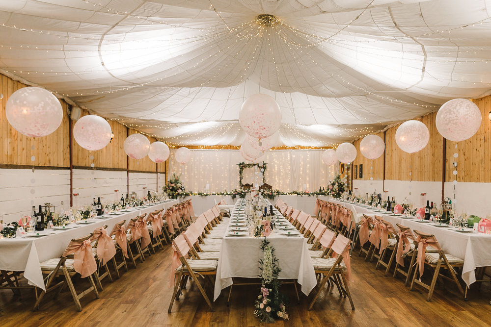 Reception Venue Room Drapes Fairy Lights Ceiling Flowers Aisle Arch Floral Pink Greenery Giant Balloons Wellbeing Farm Wedding Anna Wood Photography