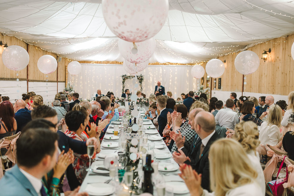 Reception Venue Room Drapes Fairy Lights Ceiling Flowers Aisle Arch Floral Pink Greenery Giant Balloons Wellbeing Farm Wedding Anna Wood Photography