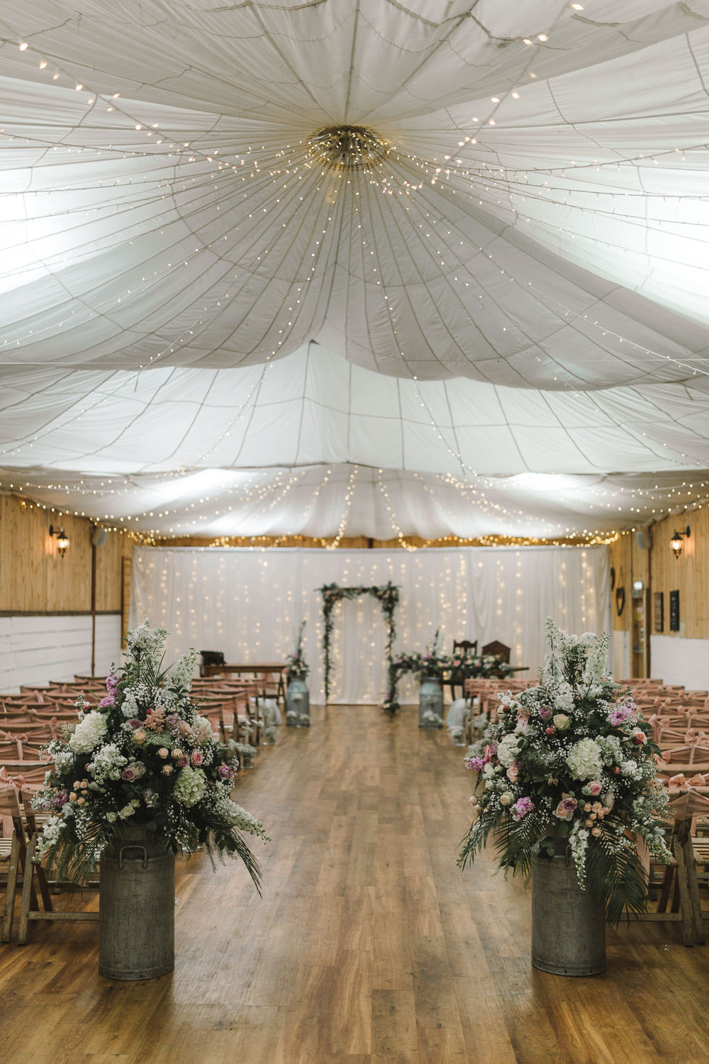Ceremony Room Drapes Fairy Lights Ceiling Flowers Aisle Arch Floral Pink Greenery Wellbeing Farm Wedding Anna Wood Photography