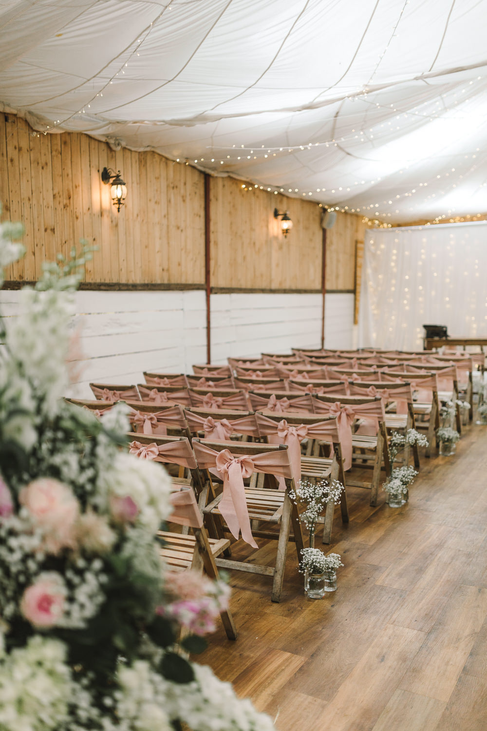 Ceremony Room Drapes Fairy Lights Ceiling Flowers Aisle Arch Floral Pink Greenery Ribbon Chairs Wellbeing Farm Wedding Anna Wood Photography
