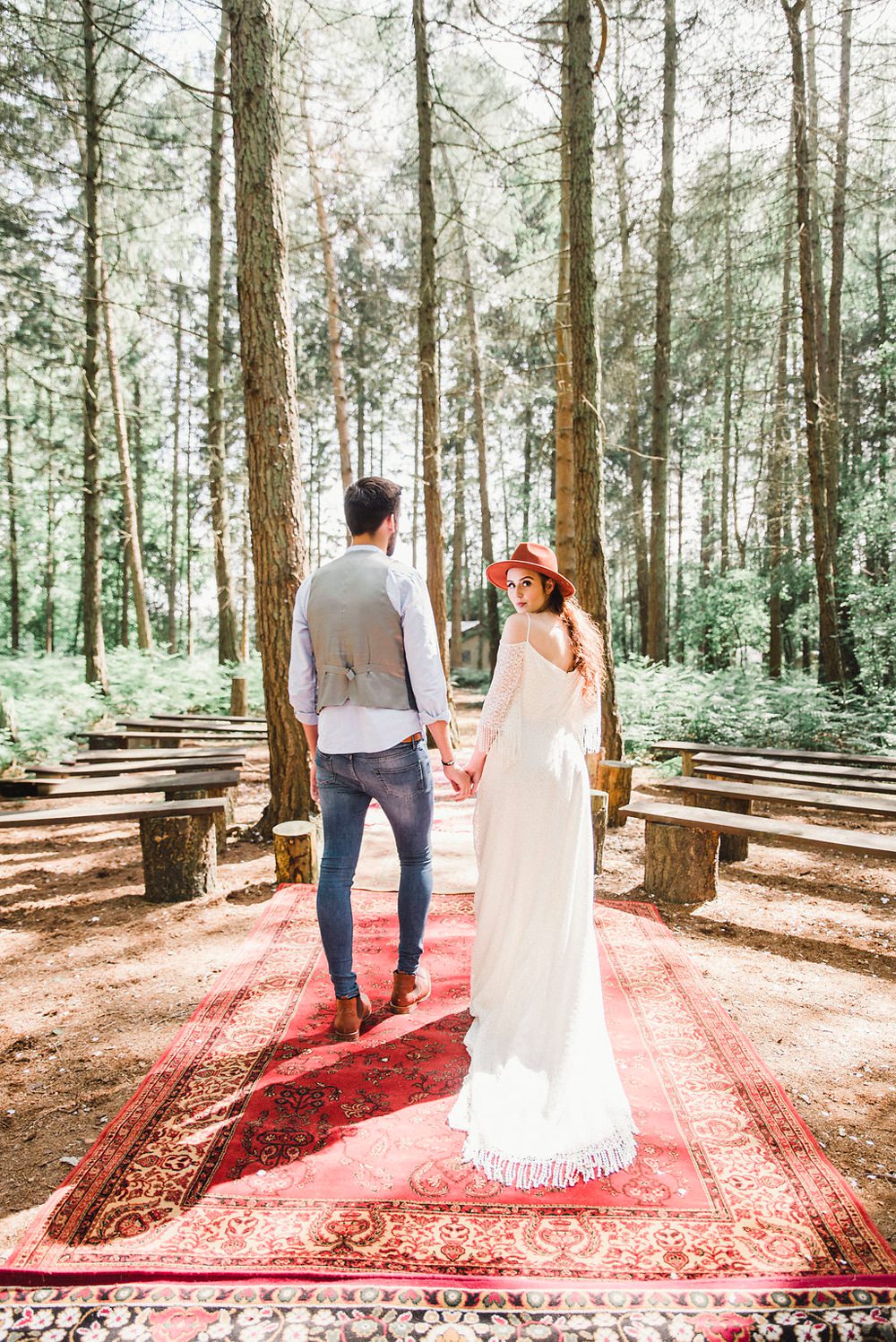Persian Rug Outdoor Aisle Ceremony Fedora Hat Accessory Bride Bridal Gown Dress Fringed Tassel Bohemian Sleeves Train Boho Woodland Wedding Ideas Camp Katur Emily Olivia Photography