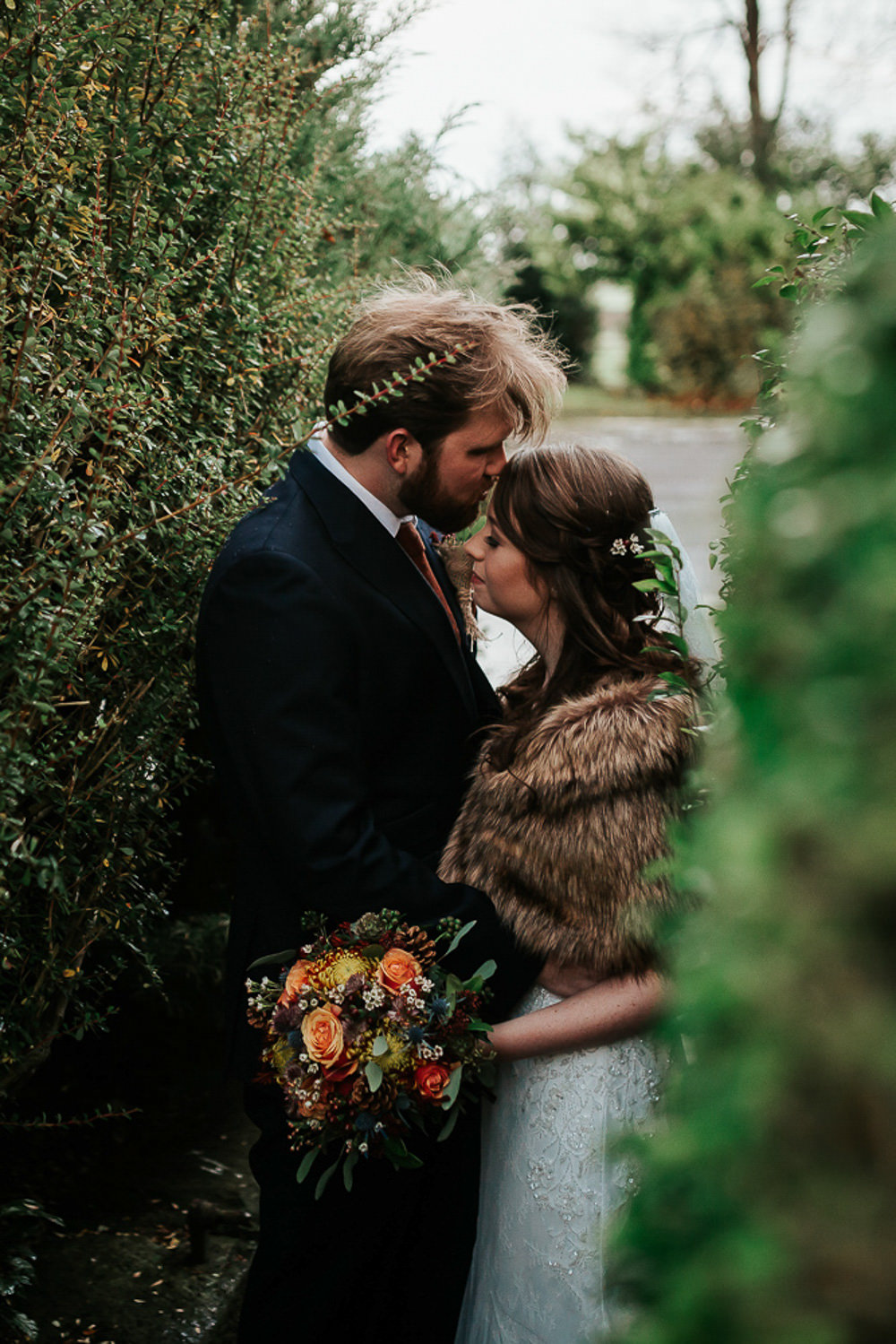 Bride Bridal Dress Cape Sleeve V Neck Lace Embellished Groom Burnt Orange Tie Black Suit Fur Stole Cape Veil Burnt Ornage Bouquet Flowers Floral Rose Cubley Hall Wedding Photography by Charli