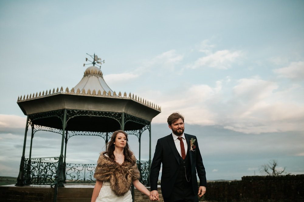 Bride Bridal Dress Cape Sleeve V Neck Lace Embellished Groom Burnt Orange Tie Black Suit Fur Stole Cape Cubley Hall Wedding Photography by Charli