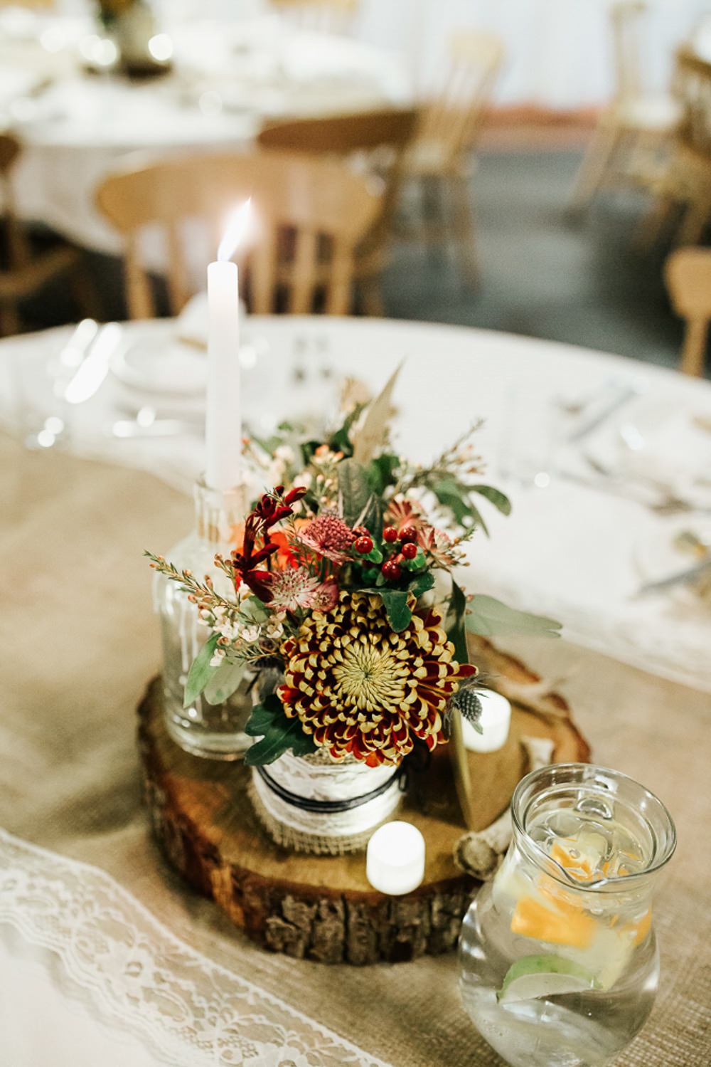 Table Centre Wood Slice Burgundy Orange Flowers Cubley Hall Wedding Photography by Charli