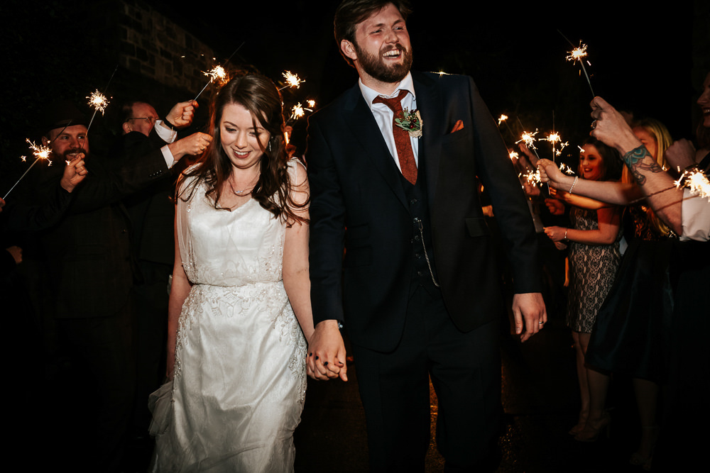 Bride Bridal Dress Cape Sleeve V Neck Lace Embellished Groom Burnt Orange Tie Black Suit Sparklers Cubley Hall Wedding Photography by Charli